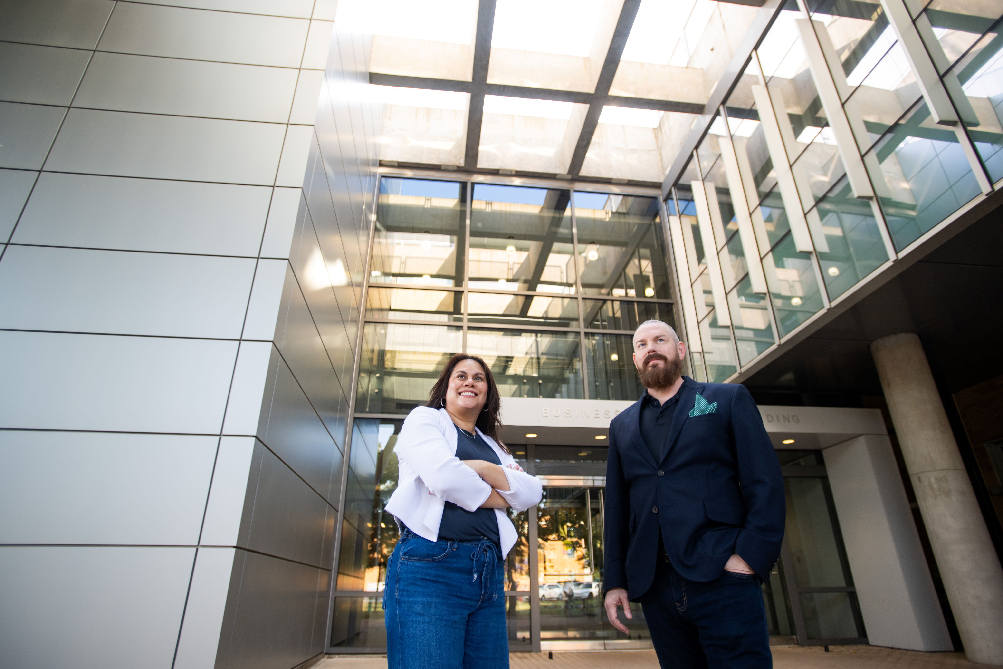 two professors standing in front of building