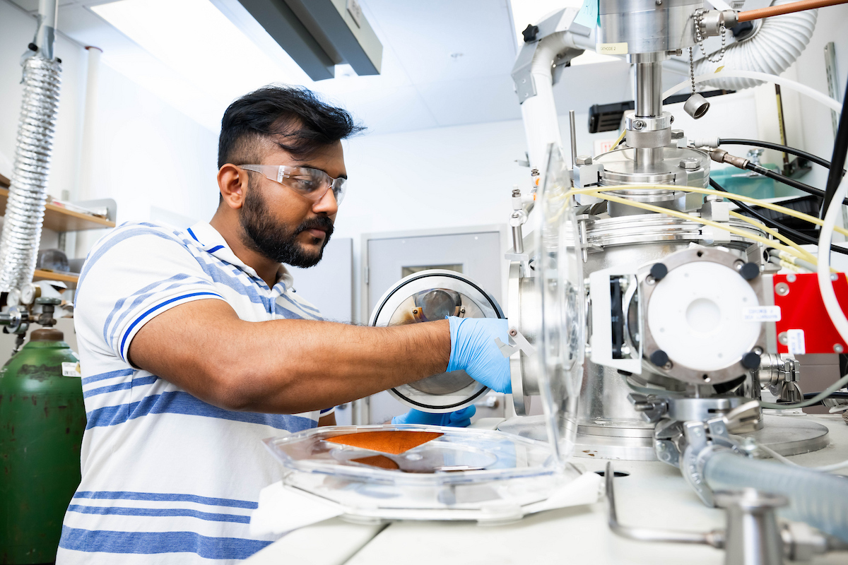 Student working with machines in a laborotory setting