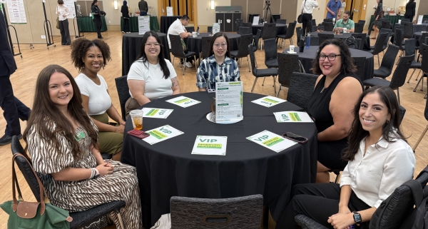 Six students sitting around a table.