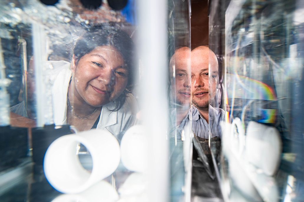 Photo of student Celeste Ortega-Rodriguez and professor Aaron Roberts working in the lab