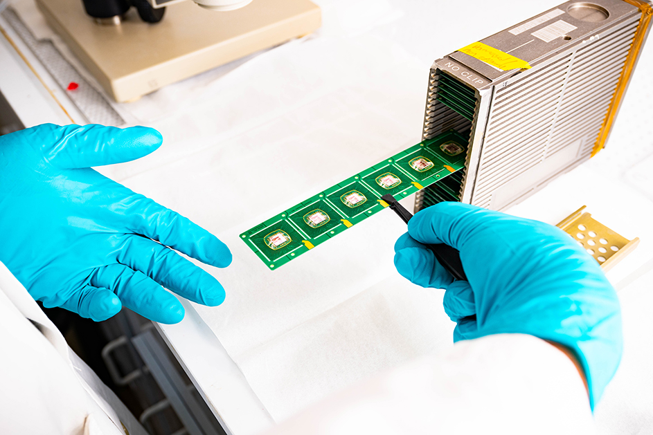 Close up photo of a researcher's hands while conducting semiconductor research
